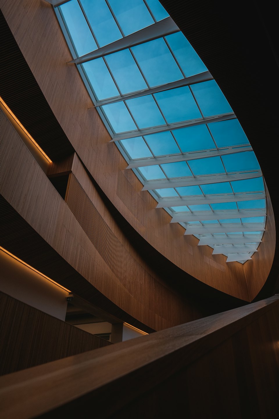 Curving wooden interior walls and ceiling with linear textures.